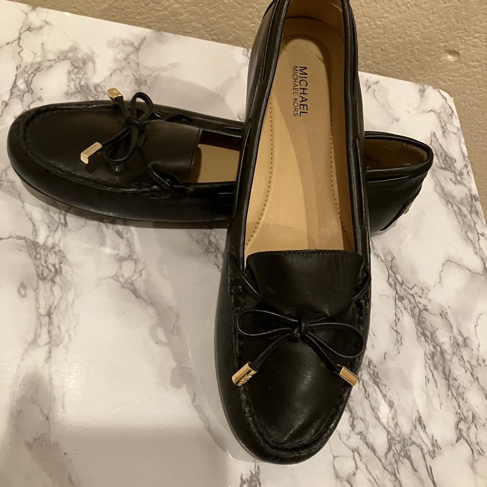 Michael Kors NWOT black loafer style shoes with gold logo lace tips. Size 8.5.